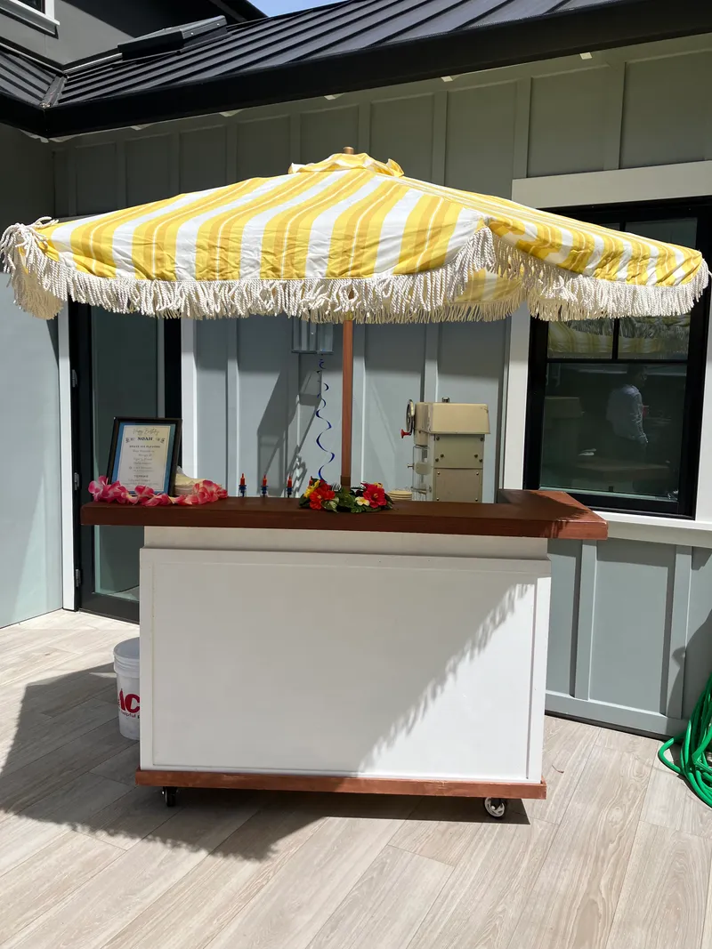 Tropics Shave Ice bar setup at an indoor event