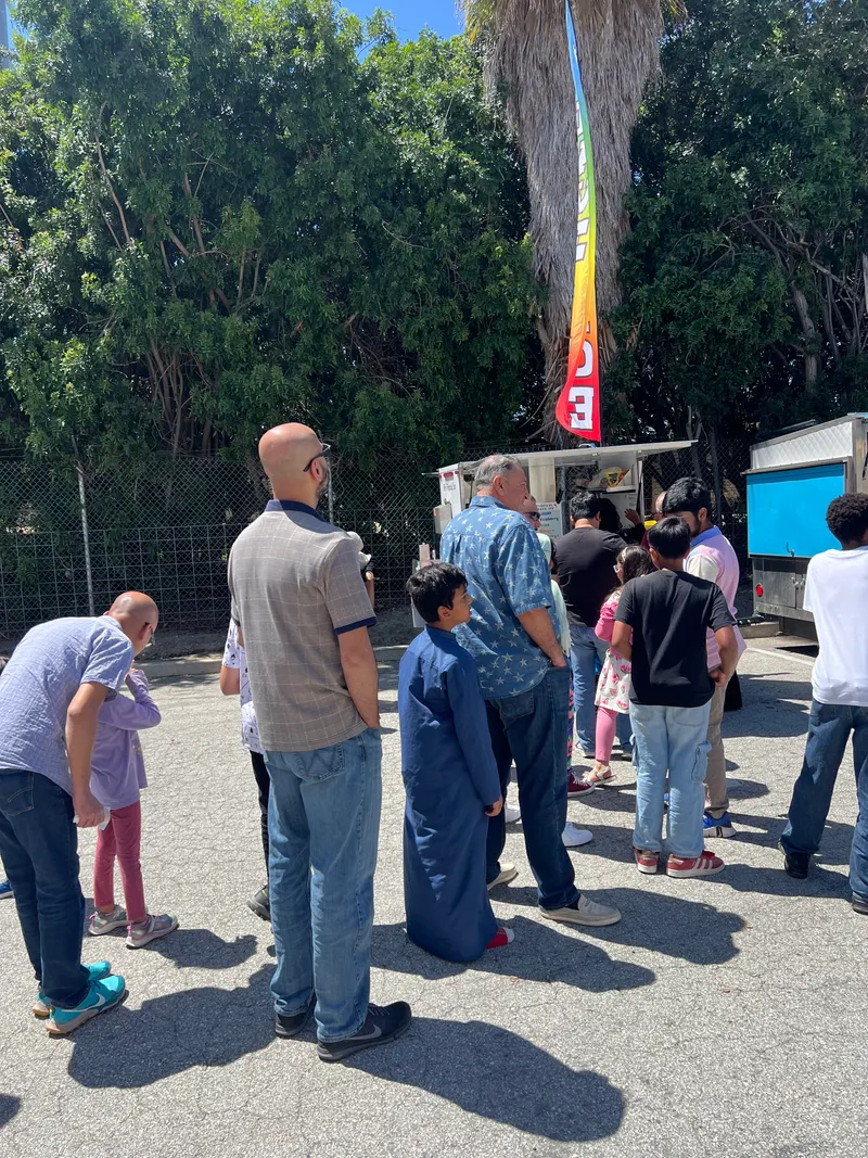 People lining up for Tropics Shave Ice at a school event